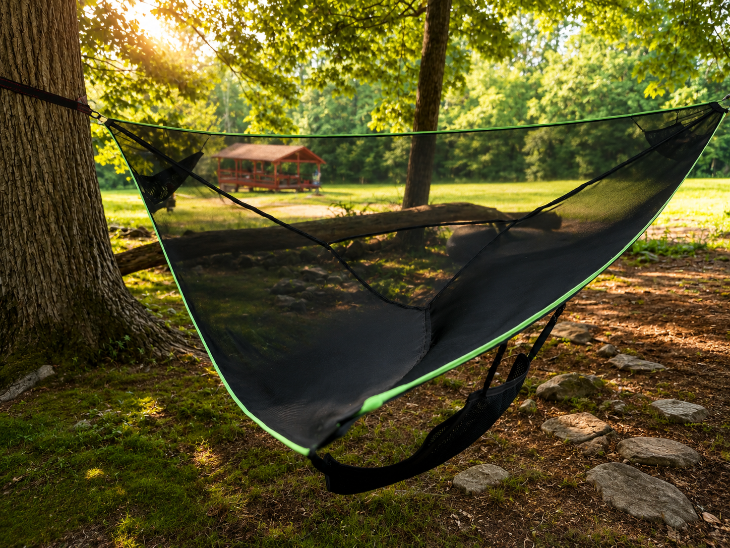 Mesh hammock strung between two trees with the red pavilion in the distance