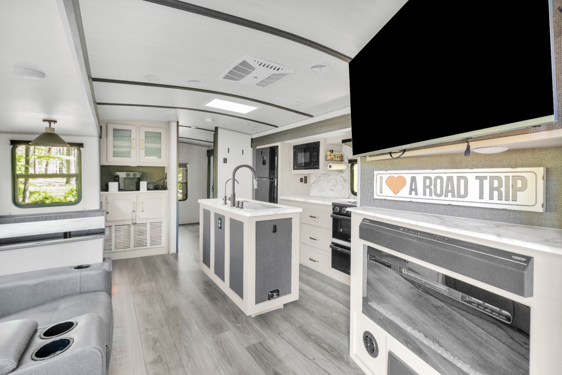 Bright open interior with kitchen island and lounge seating
